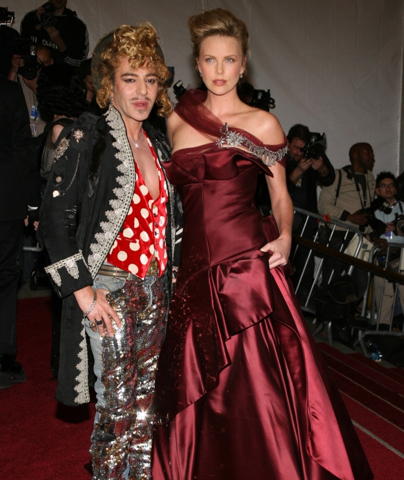 Charlize Theron and John Galliano | Getty Images Photo by Sylvain Gaboury/FilmMagic